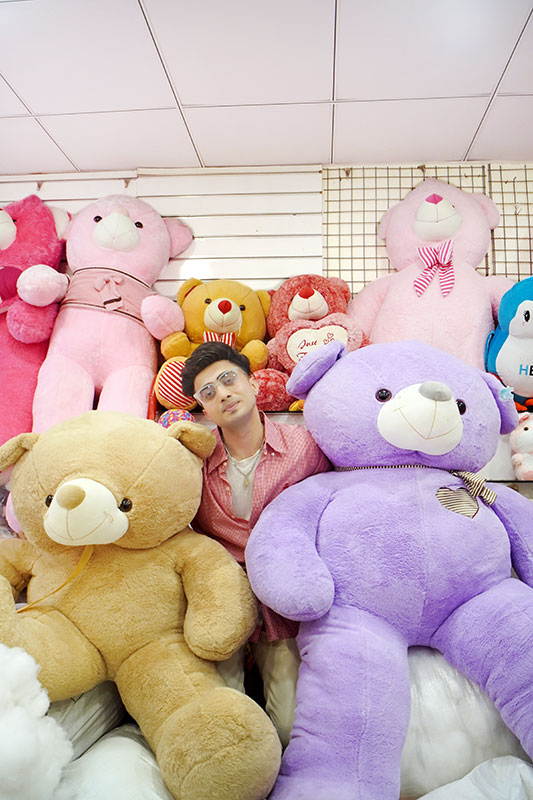 Handsome boy pic 2026 surrounded by giant teddy bears showing stylish and cool Indian boy vibes.