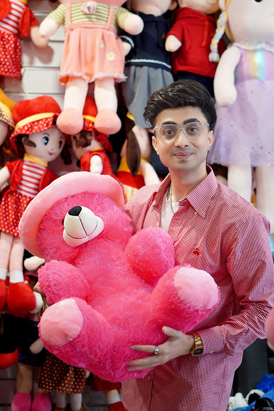 Indian Handsome stylish boy 2026 holding pink teddy bear with charming smile and confident Indian boy look.